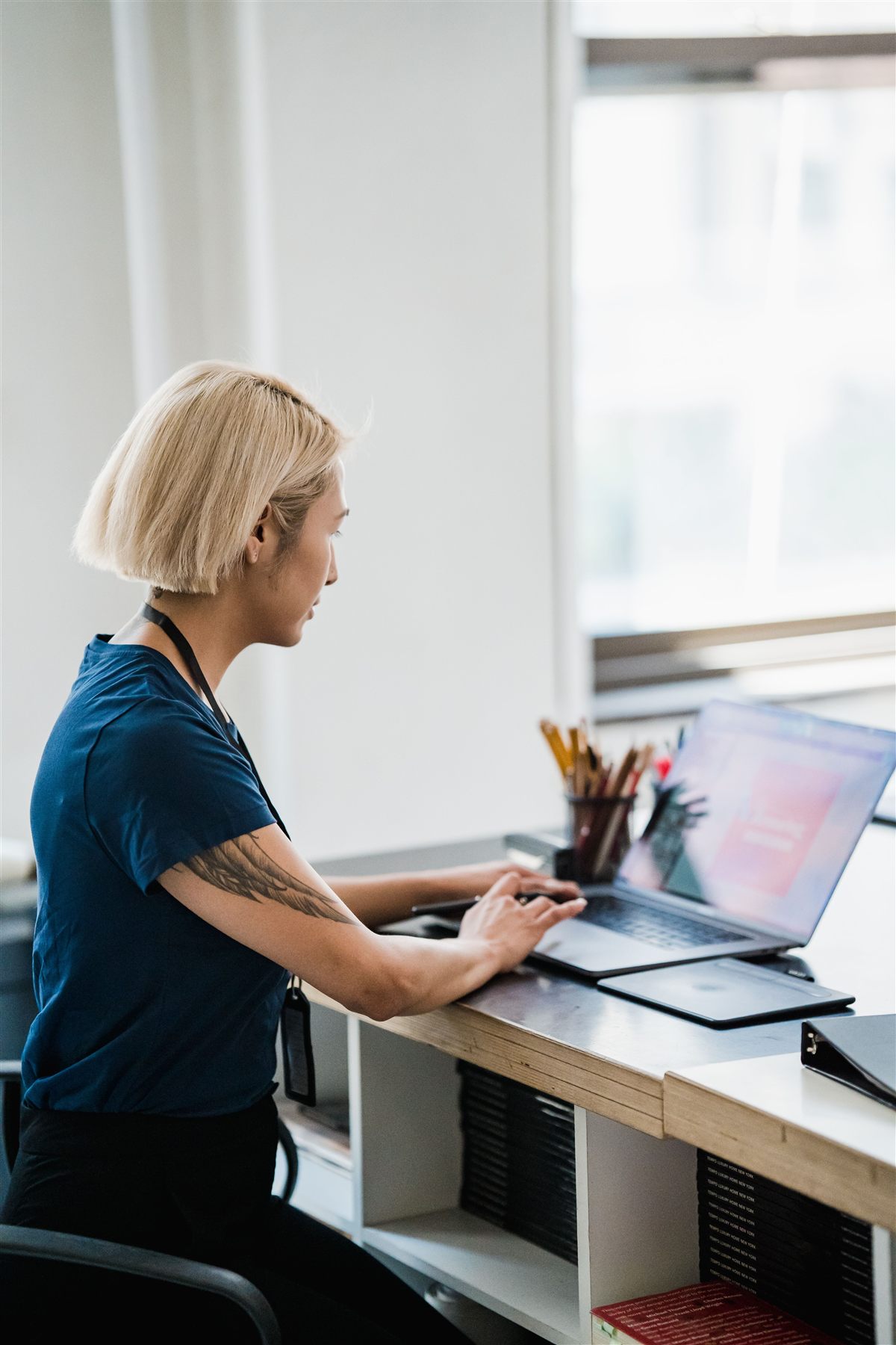 Professional using a laptop in a modern workplace