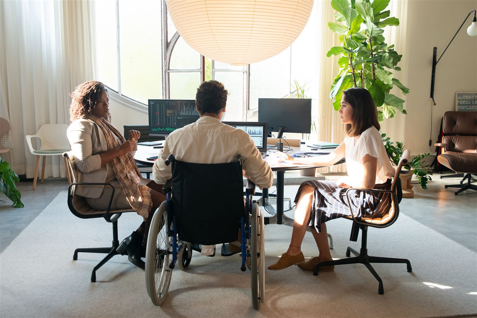 Colleagues from a diverse team meeting in a modern office